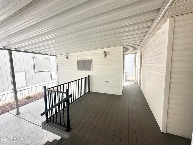 a view of a hallway with wooden floor and stairs
