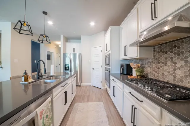 a stove top oven sitting inside of a kitchen