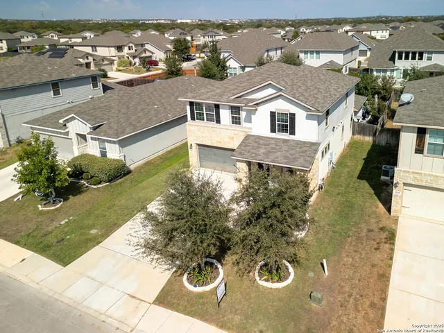 an aerial view of a house with yard