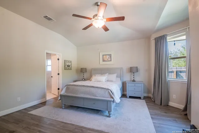 a spacious bedroom with a bed and a chandelier
