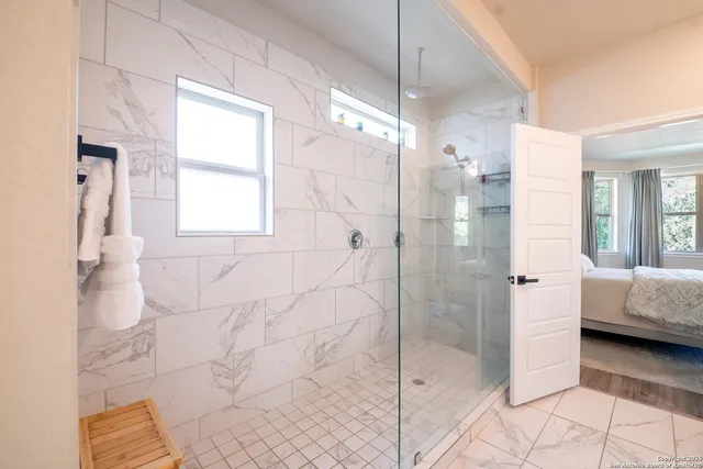a bathroom with a bathtub and a shower