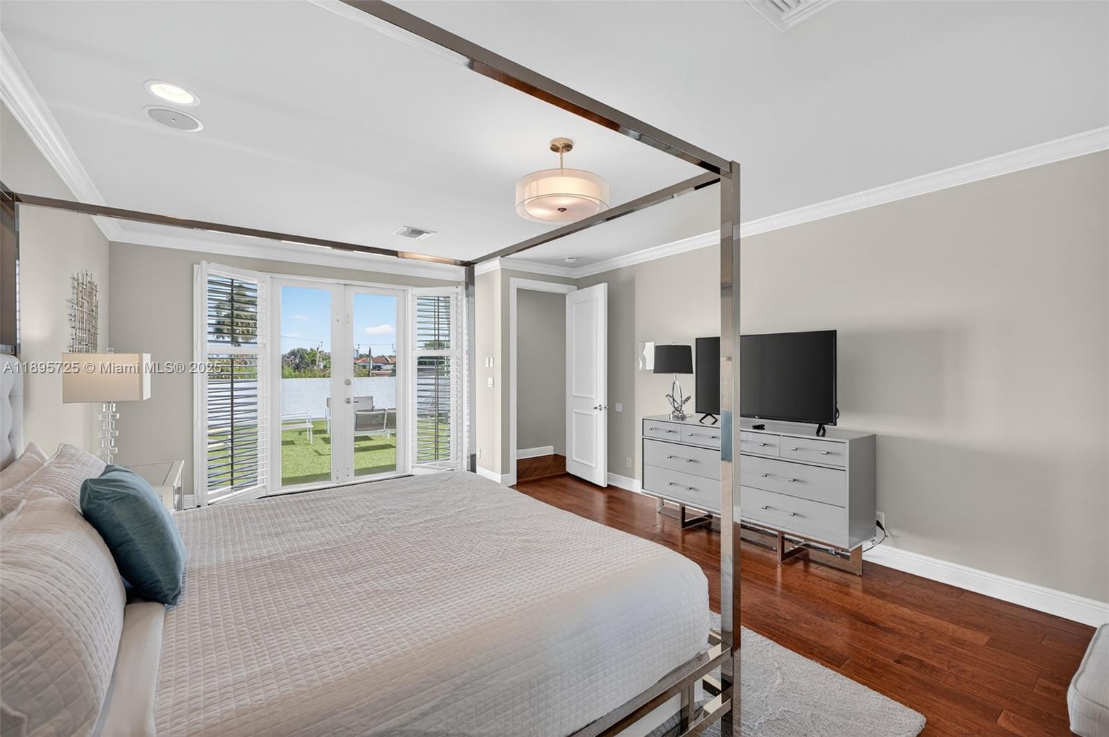 312 Northeast 12th Avenue Fort Lauderdale, FL 33301 - Photo 23 of 39 a bedroom with a bed and a flat tv screen on the dresser