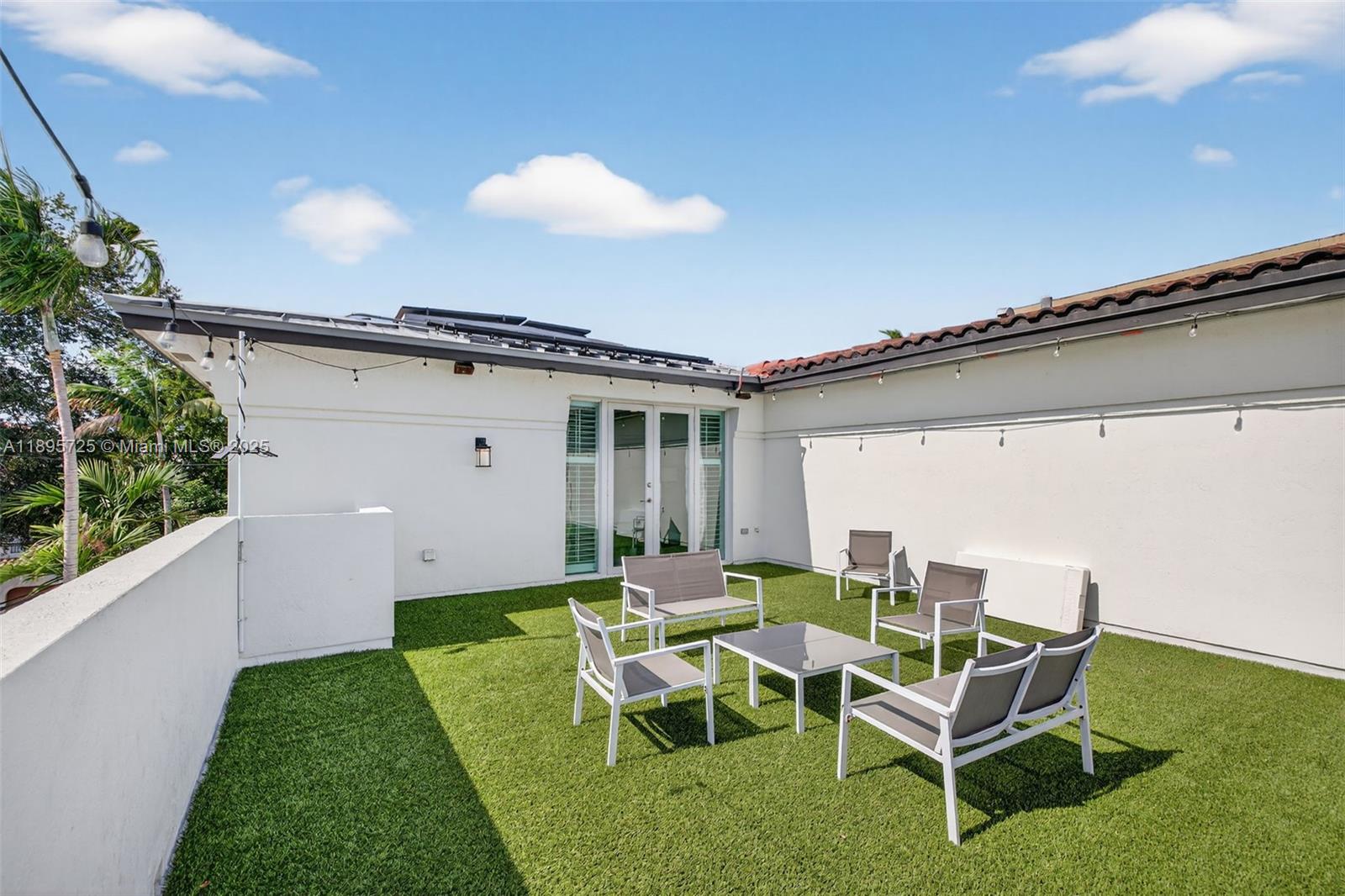 312 Northeast 12th Avenue Fort Lauderdale, FL 33301 - Photo 28 of 39 a view of a patio with table and chairs with wooden floor