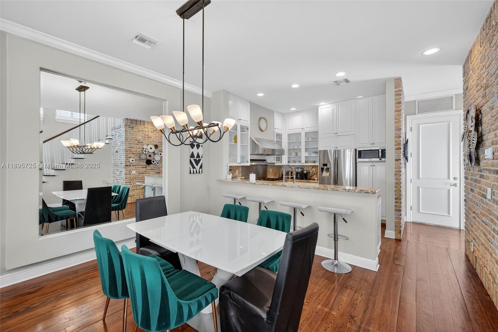 312 Northeast 12th Avenue Fort Lauderdale, FL 33301 - Photo 6 of 39 a view of a dining room and livingroom with furniture wooden floor a chandelier