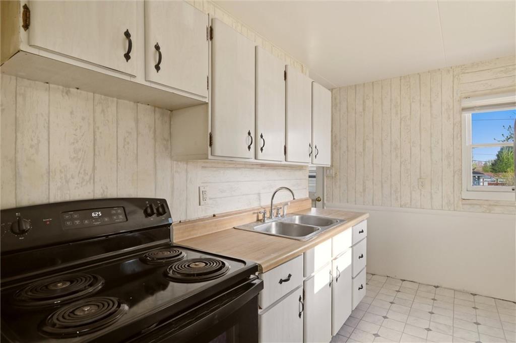 1417 Randolph Street New Castle, PA 16101 - Photo 10 of 15 a kitchen with a stove and a white cabinets