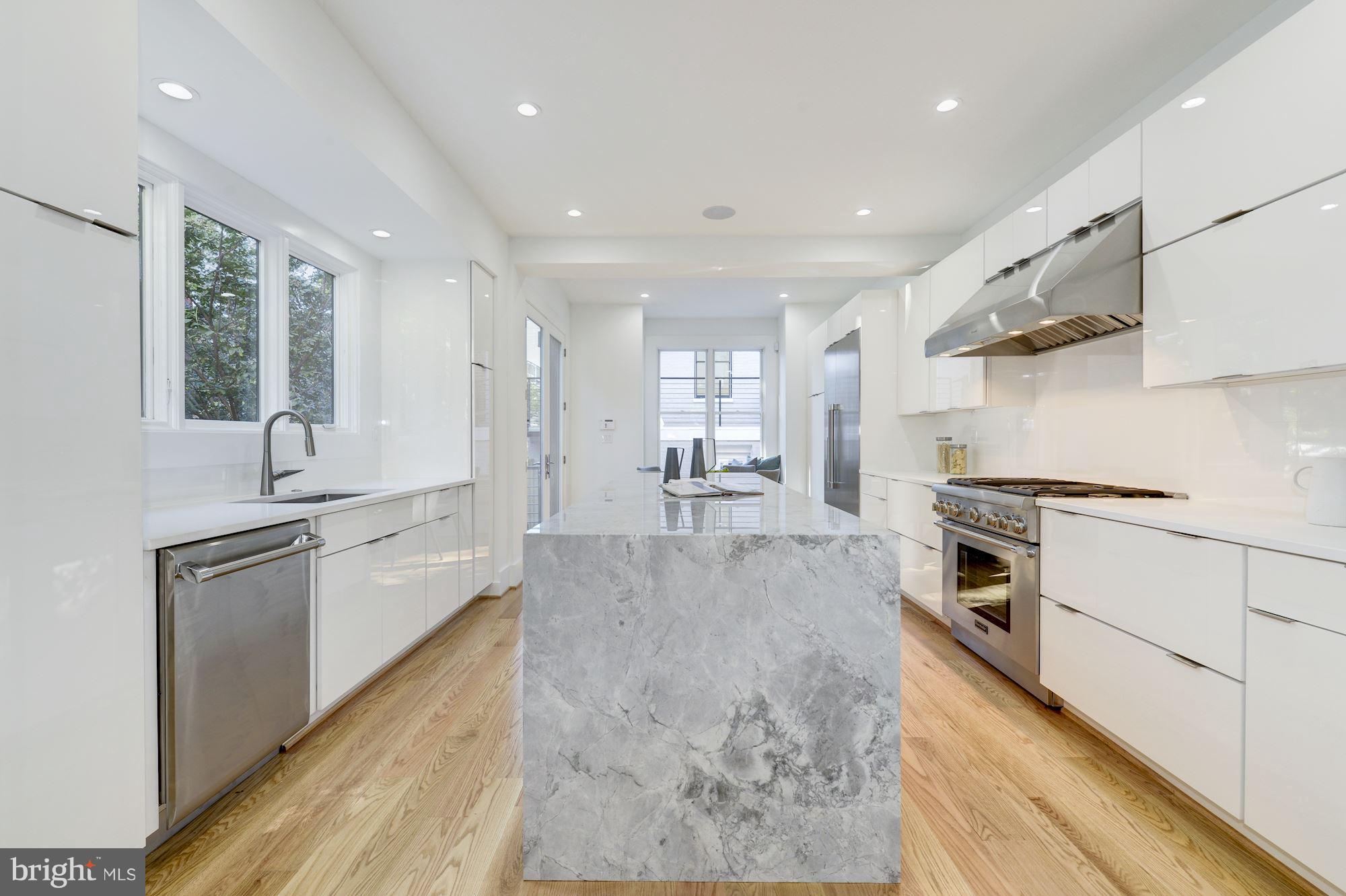 17 7th Street Southeast Washington, DC 20003 - Photo 12 of 29 a large kitchen with stainless steel appliances granite countertop a lot of counter space and wooden floors