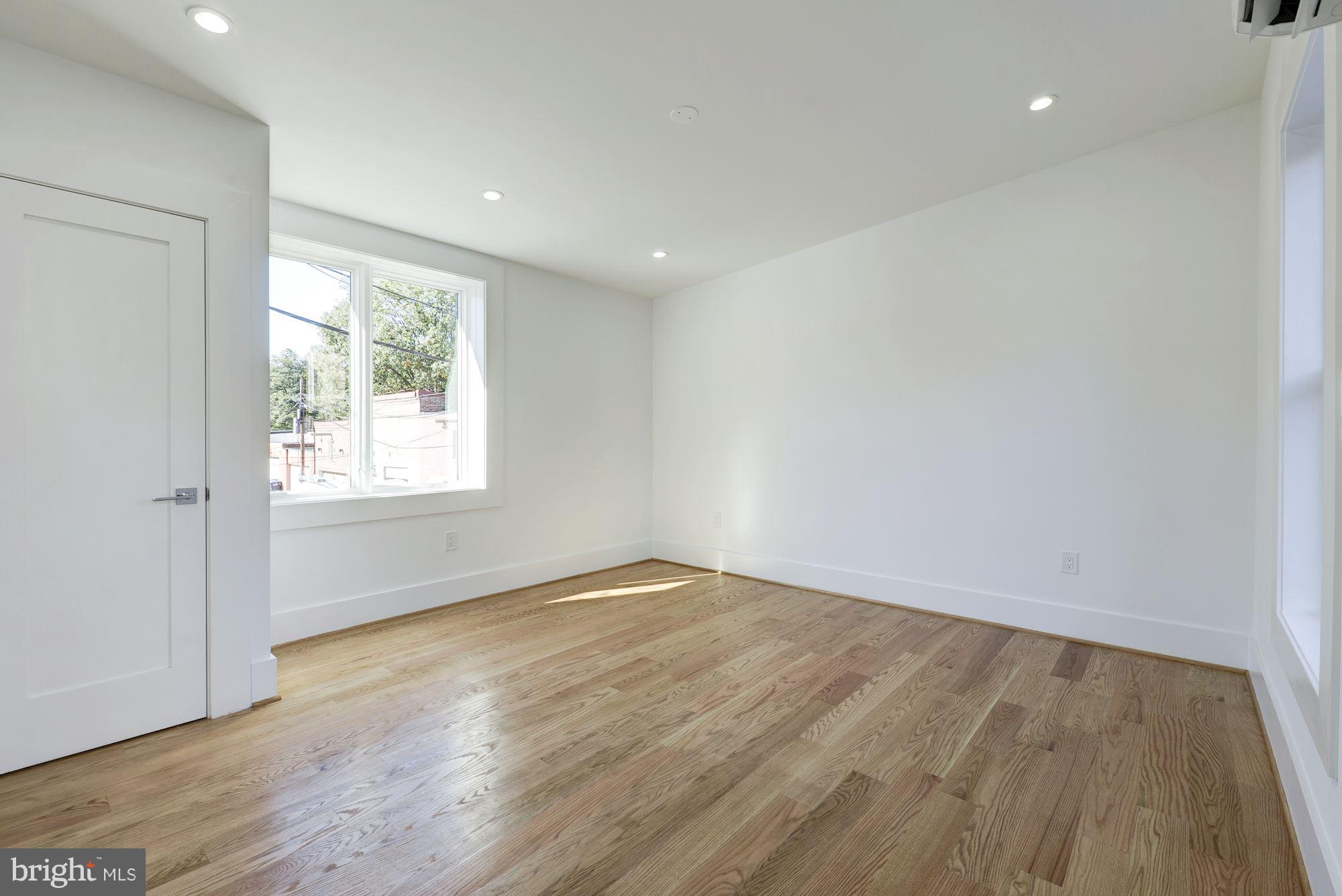 17 7th Street Southeast Washington, DC 20003 - Photo 17 of 29 an empty room with wooden floor and windows