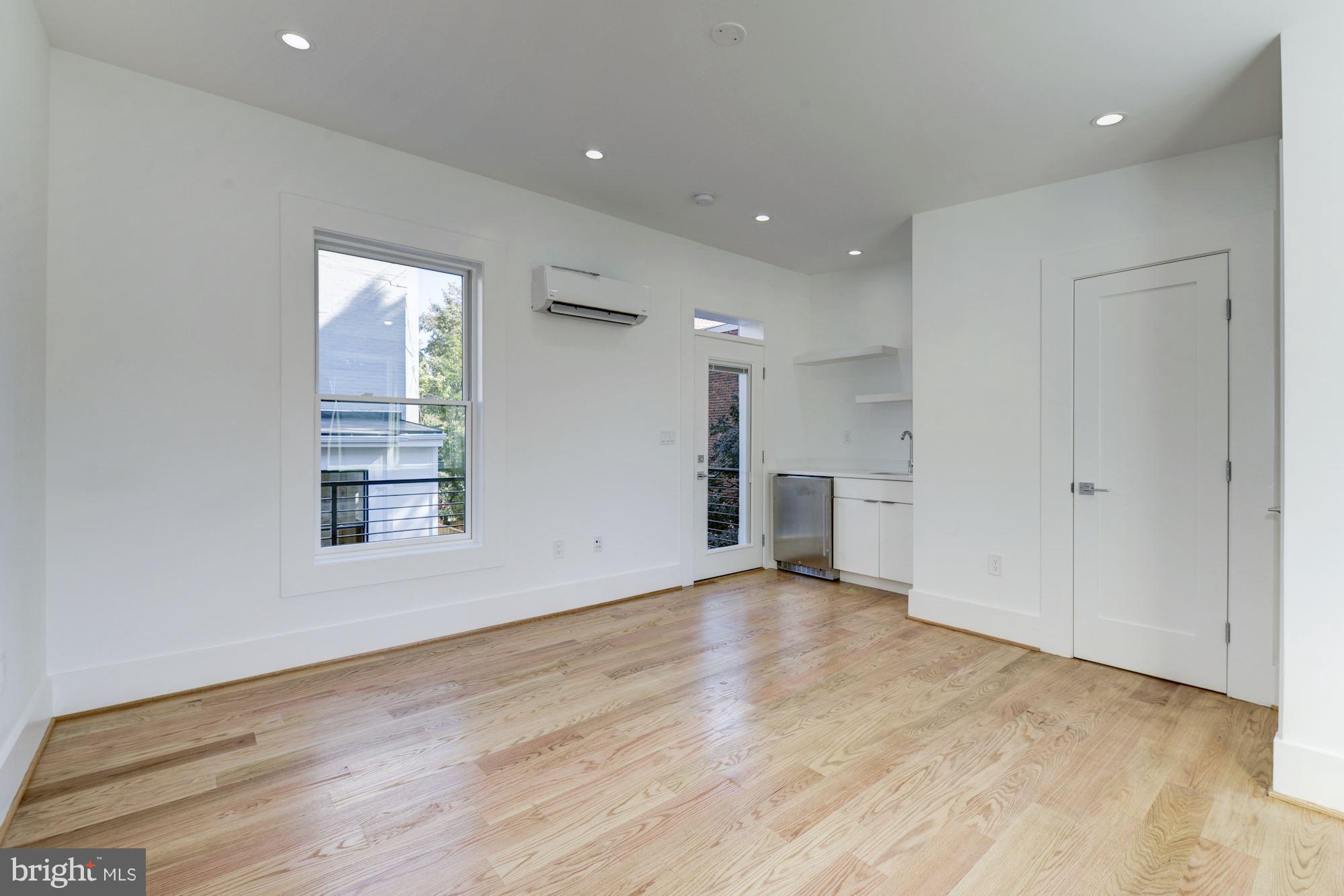 17 7th Street Southeast Washington, DC 20003 - Photo 18 of 29 wooden floor in an empty room with a window
