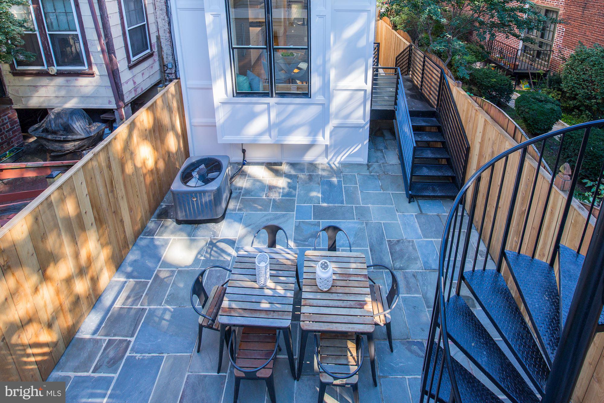 17 7th Street Southeast Washington, DC 20003 - Photo 27 of 29 a view of a patio with table and chairs with wooden floor and fence