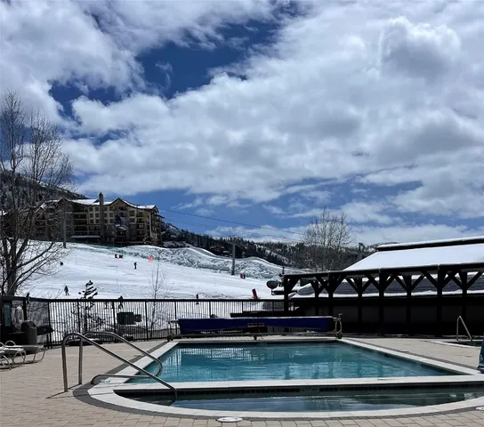 a view of a swimming pool with furniture
