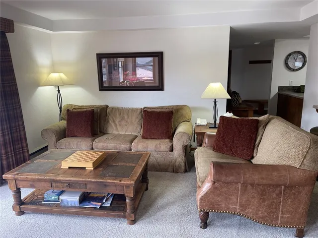 a living room with furniture and a lamp