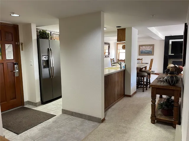 a view of a kitchen with refrigerator and a kitchen