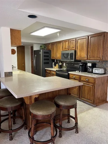 a kitchen with a table chairs sink and cabinets