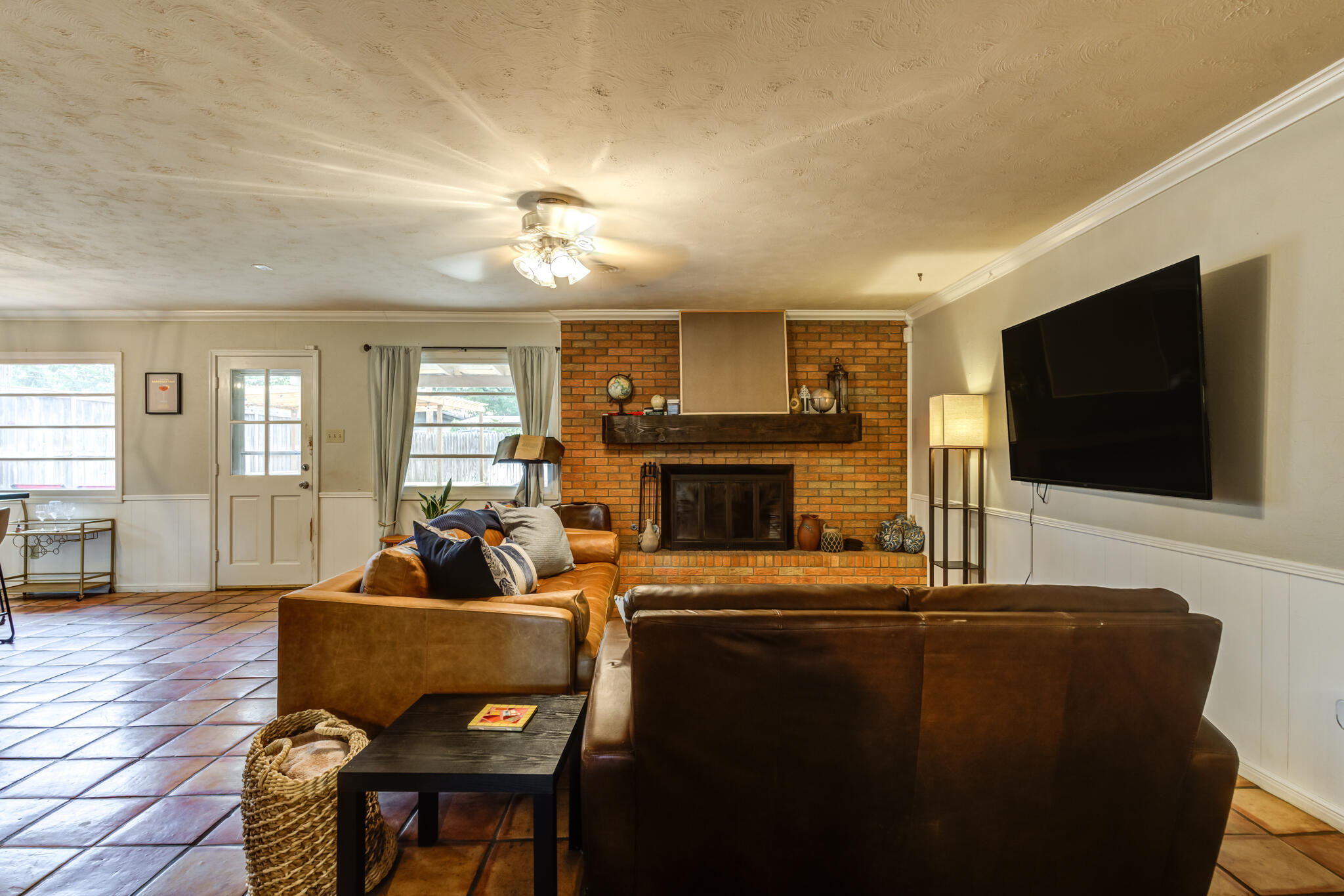 3420 60th Street Lubbock, TX 79413 - Photo 11 of 57 a living room with furniture a flat screen tv and a fireplace