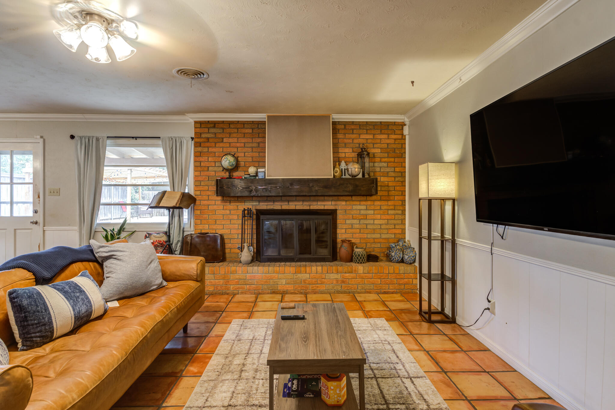 3420 60th Street Lubbock, TX 79413 - Photo 12 of 57 a living room with furniture and a flat screen tv