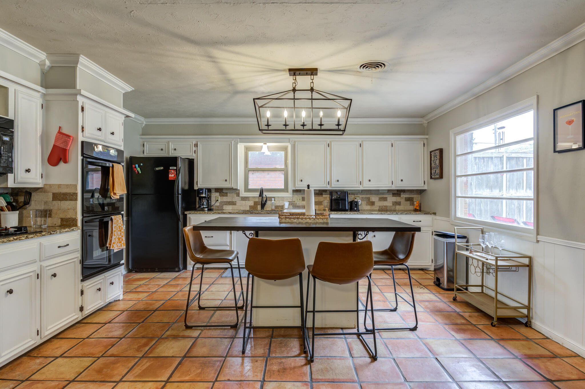 3420 60th Street Lubbock, TX 79413 - Photo 25 of 57 a kitchen with stainless steel appliances granite countertop a sink and a refrigerator