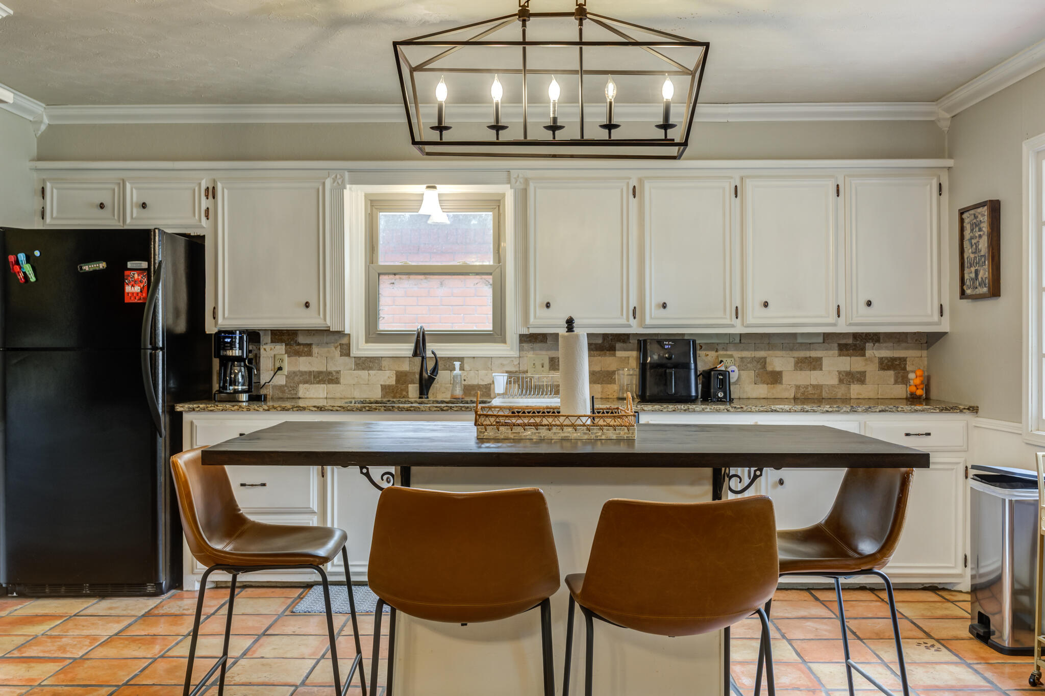 3420 60th Street Lubbock, TX 79413 - Photo 26 of 57 a kitchen with stainless steel appliances granite countertop a dining table chairs refrigerator and cabinets