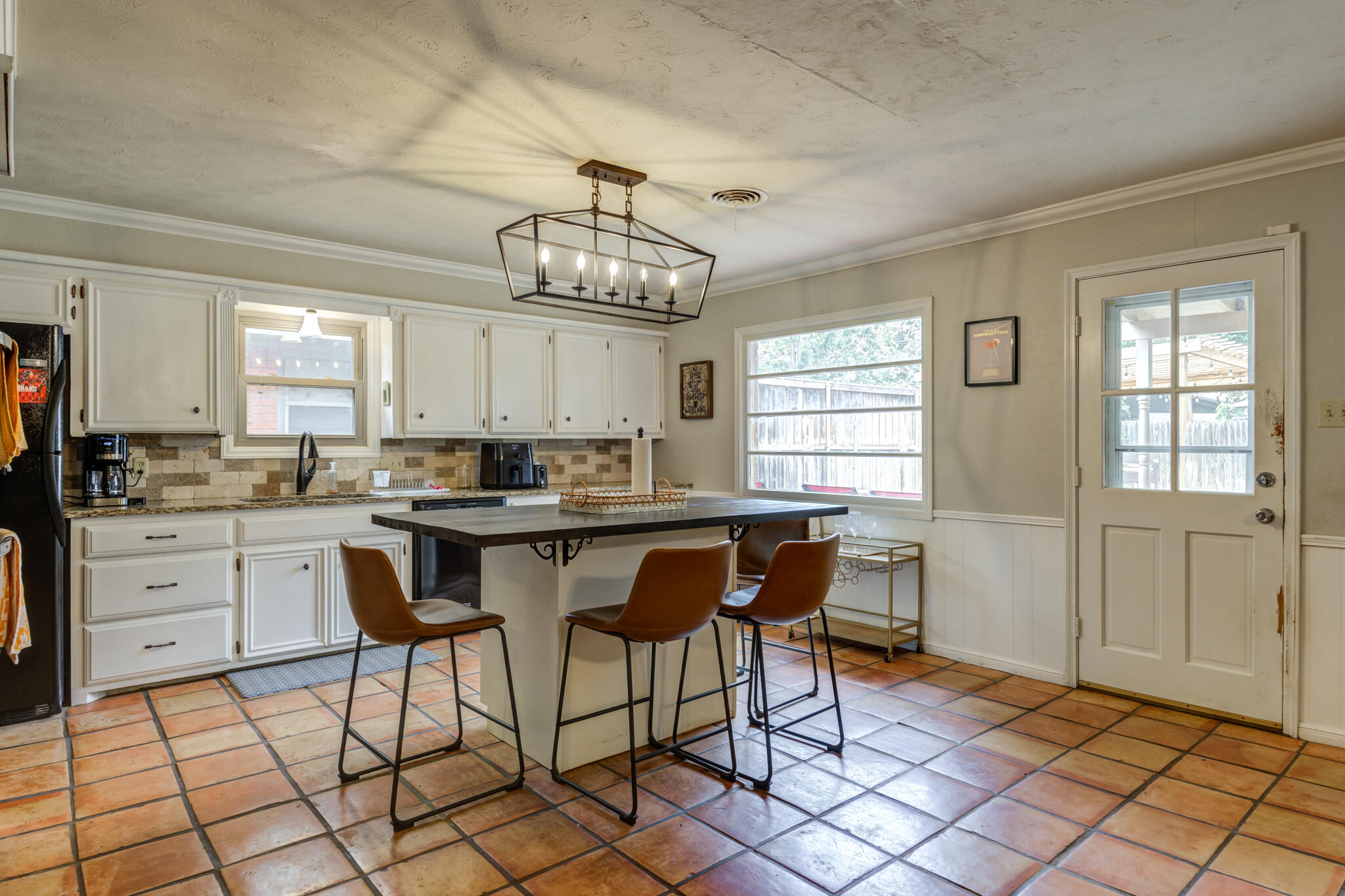 3420 60th Street Lubbock, TX 79413 - Photo 27 of 57 a open dining room with stainless steel appliances kitchen island granite countertop furniture and a chandelier