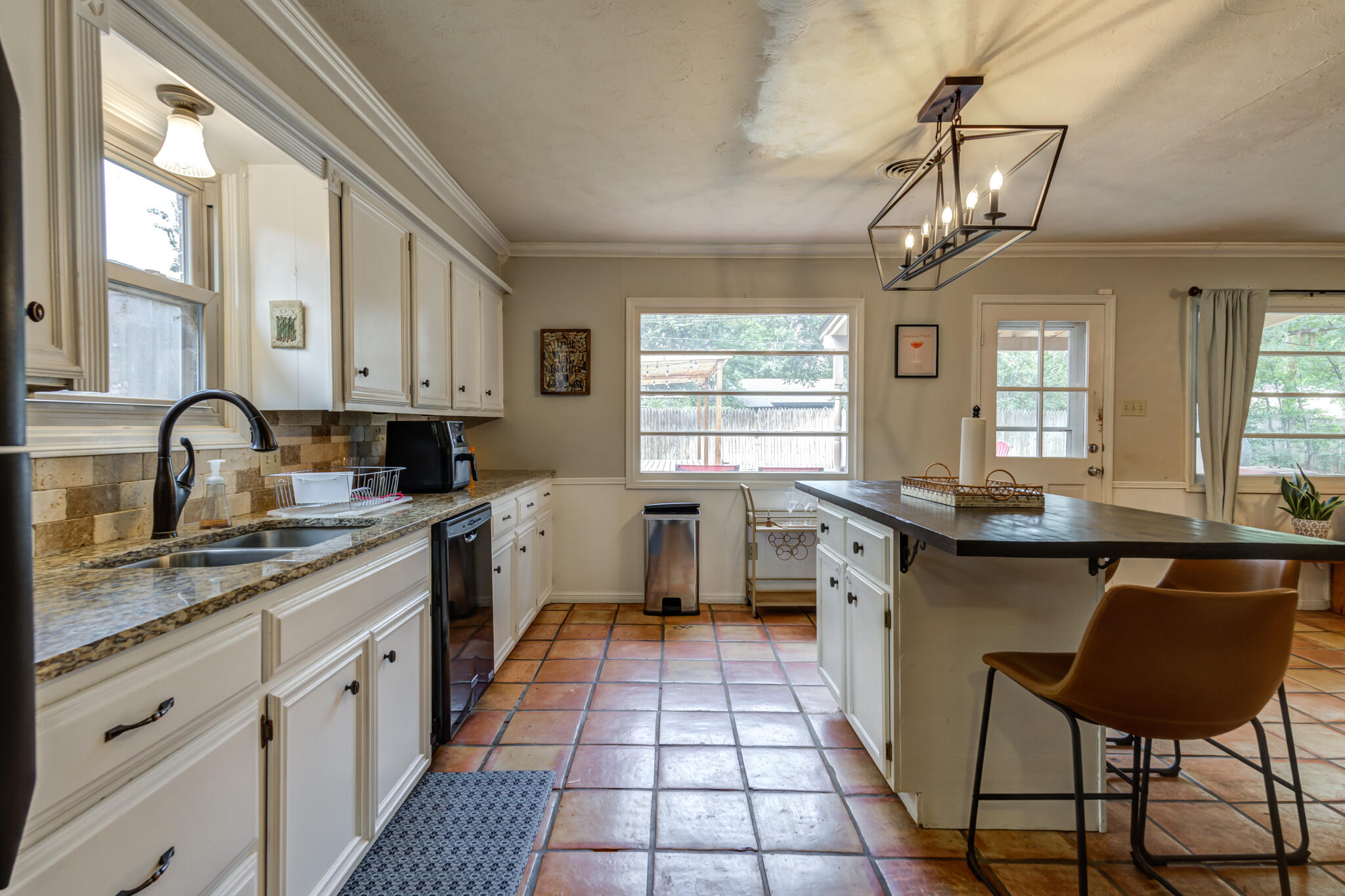 3420 60th Street Lubbock, TX 79413 - Photo 31 of 57 a kitchen with a sink a counter space appliances and cabinets