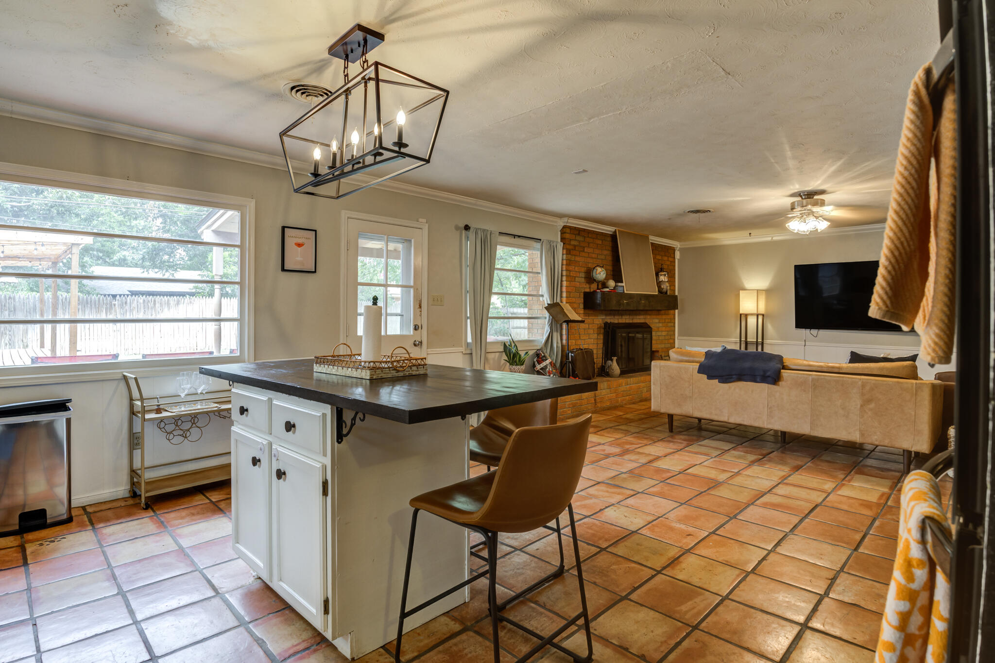 3420 60th Street Lubbock, TX 79413 - Photo 32 of 57 a kitchen with stainless steel appliances granite countertop a stove top oven a sink dishwasher a dining table and chairs with wooden floor