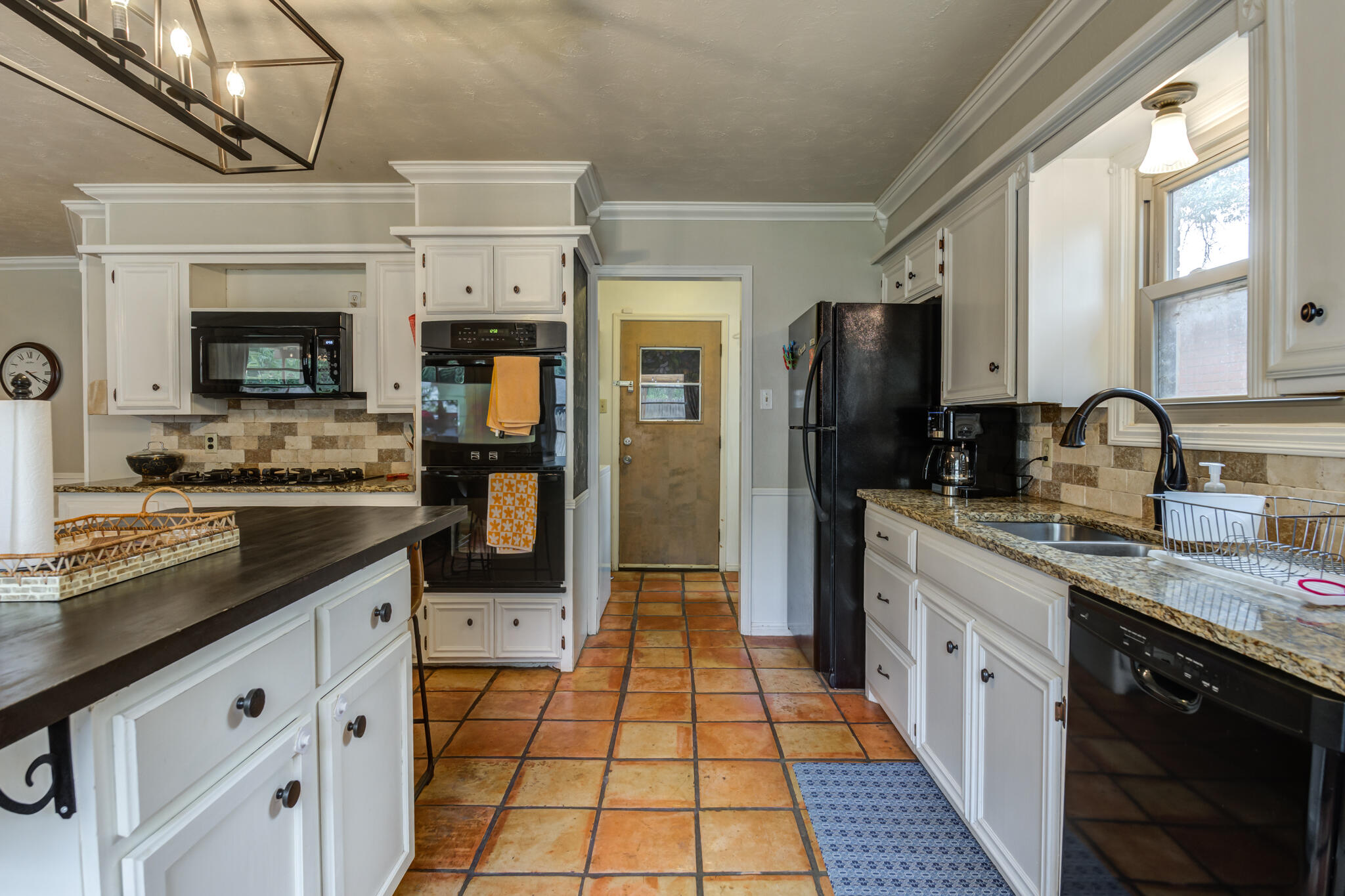 3420 60th Street Lubbock, TX 79413 - Photo 33 of 57 a kitchen with stainless steel appliances granite countertop a stove a sink and a refrigerator