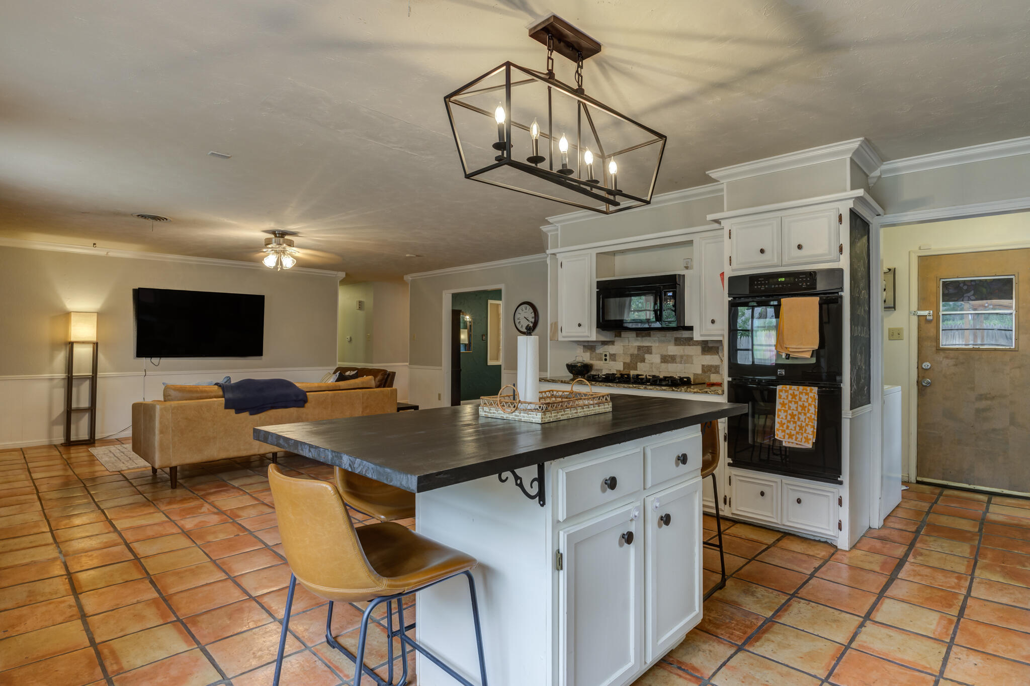 3420 60th Street Lubbock, TX 79413 - Photo 35 of 57 a kitchen with stainless steel appliances kitchen island granite countertop a sink and cabinets