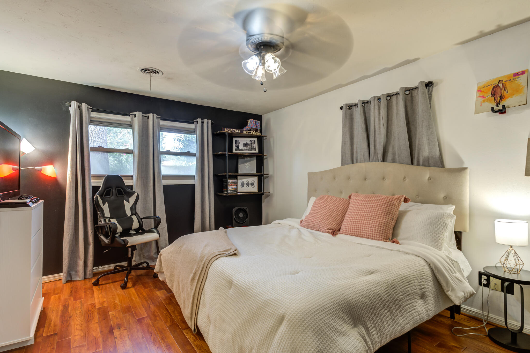 3420 60th Street Lubbock, TX 79413 - Photo 47 of 57 a bedroom with a bed and a chandelier