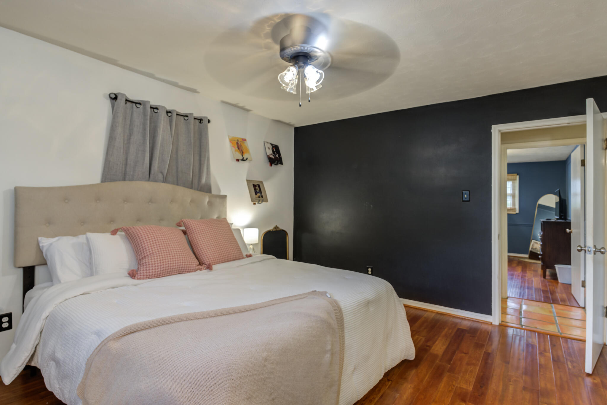 3420 60th Street Lubbock, TX 79413 - Photo 48 of 57 a bedroom with a bed and a chandelier