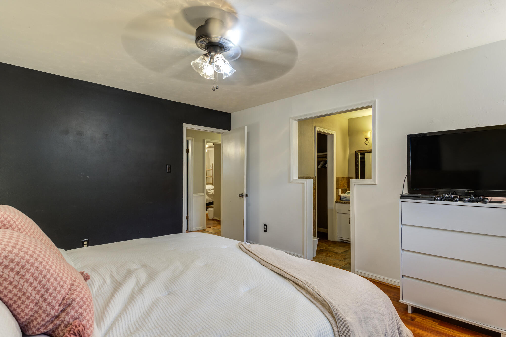 3420 60th Street Lubbock, TX 79413 - Photo 49 of 57 a bedroom with a bed and a flat screen tv