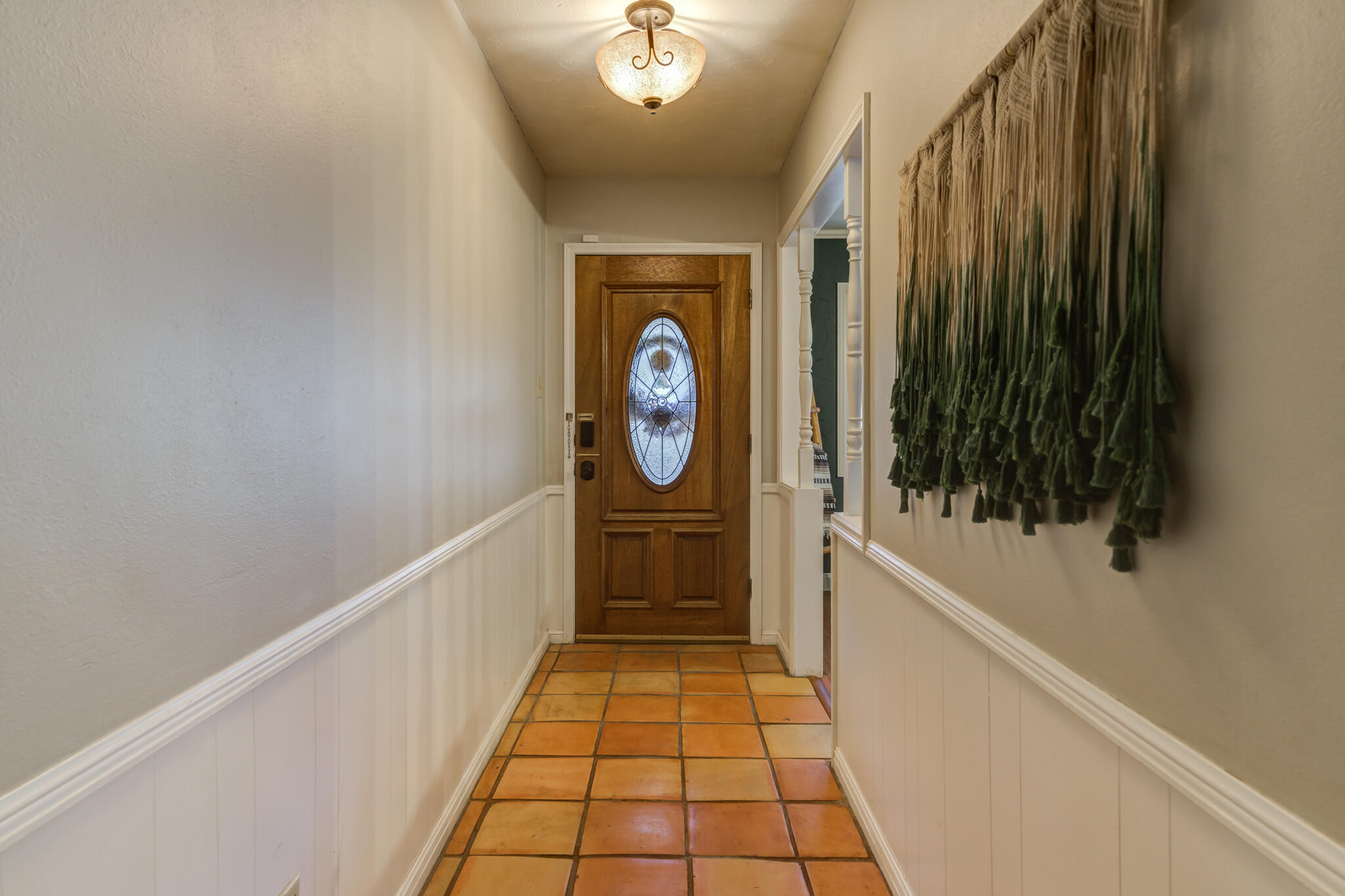 3420 60th Street Lubbock, TX 79413 - Photo 5 of 57 a hallway with painting on the wall and a shower