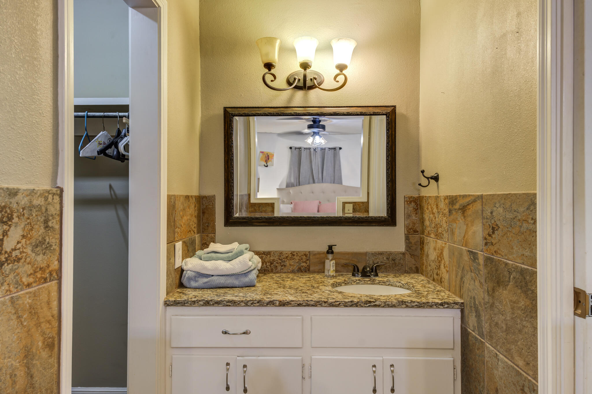 3420 60th Street Lubbock, TX 79413 - Photo 51 of 57 a bathroom with a granite countertop sink and a mirror