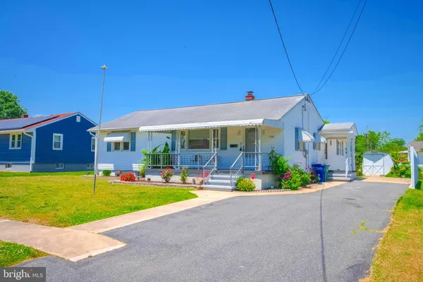 a front view of house with outdoor seating and yard