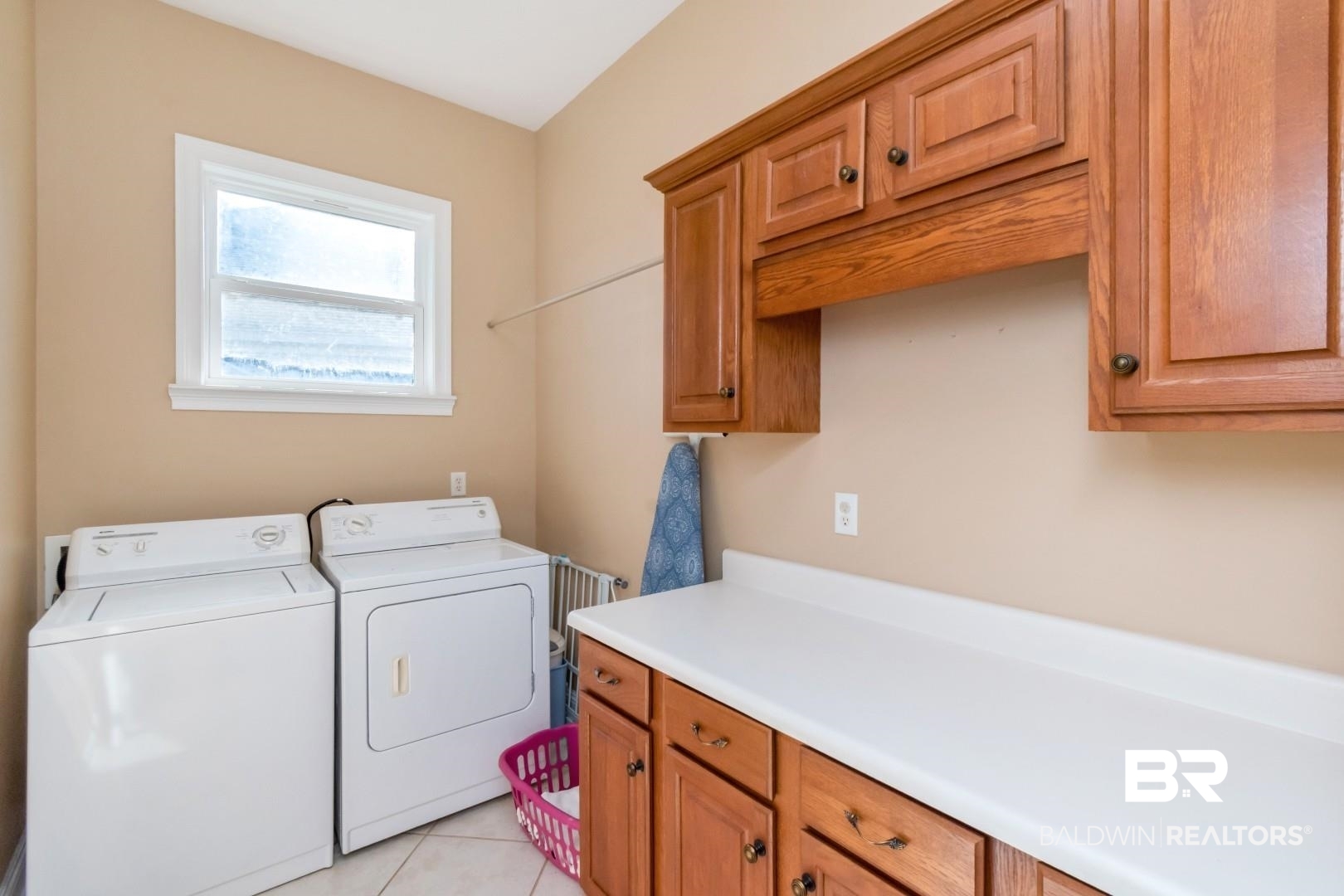 9905 Carnoustie Court Foley, AL 36535 - Photo 19 of 31 Laundry area featuring light tile patterned flooring, cabinet space, and independent washer and dryer