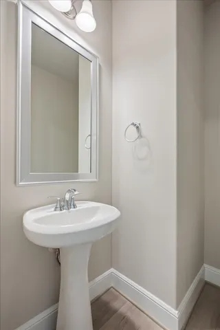 a view of a hallway with wooden floor and stairs