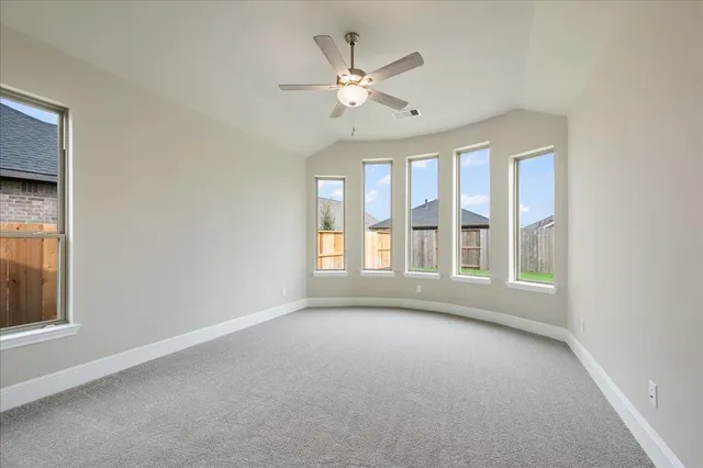 a bedroom with a large bed and a flat screen tv