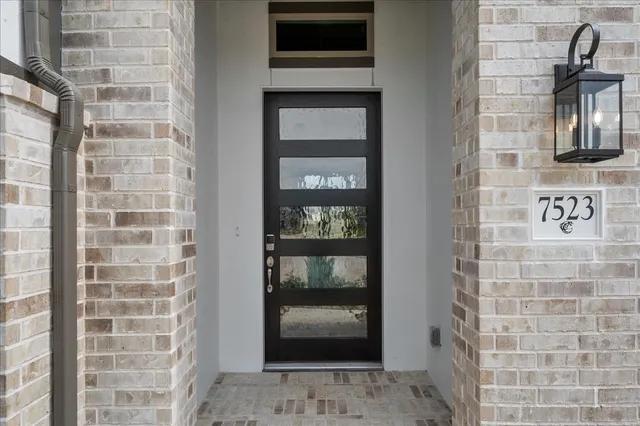 a view of a hallway view with wooden floor and staircase