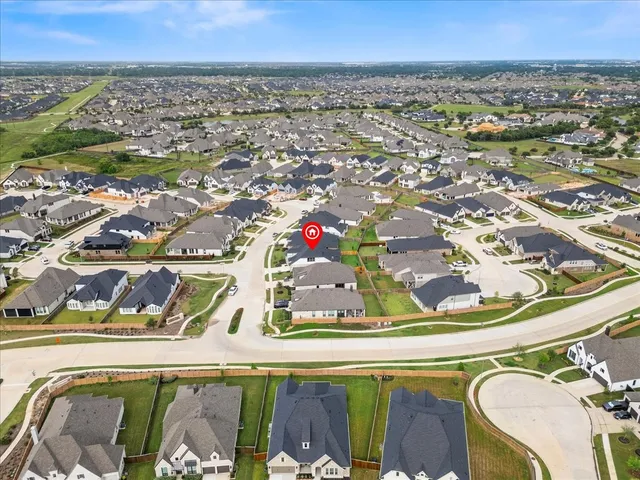 an aerial view of a house with a yard