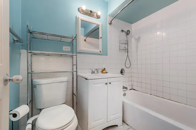 a bathroom with a toilet sink and shower