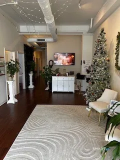 a bedroom with furniture and a flat screen tv