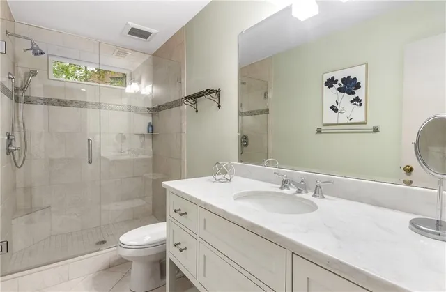 a spacious bedroom with a bed and a large window