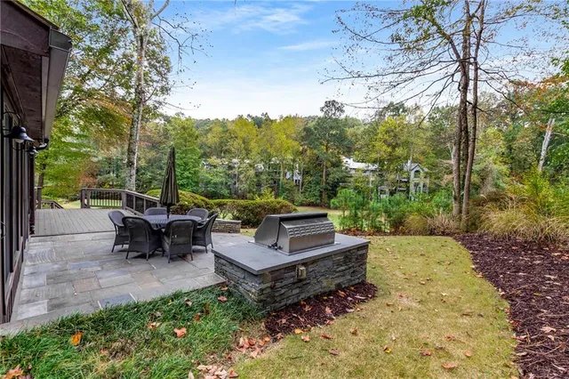 a view of a patio with a table chairs and garden