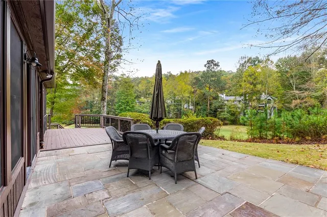 a front view of house with yard and trees around