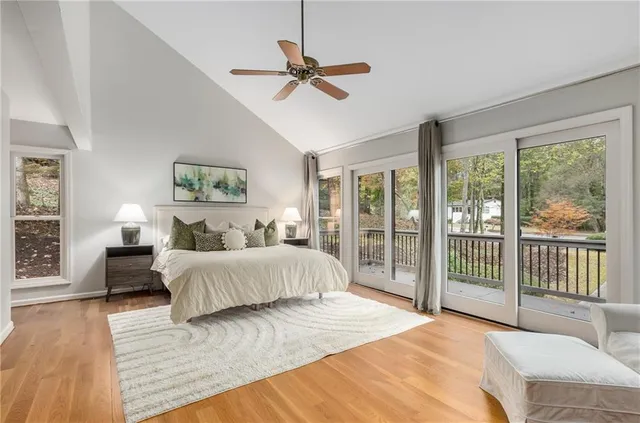a bedroom with a large bed and a large window
