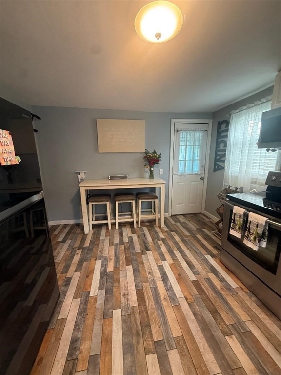66 Powell Avenue Springfield, MA 01118 - Photo 12 of 31 a living room with a piano and wooden floor