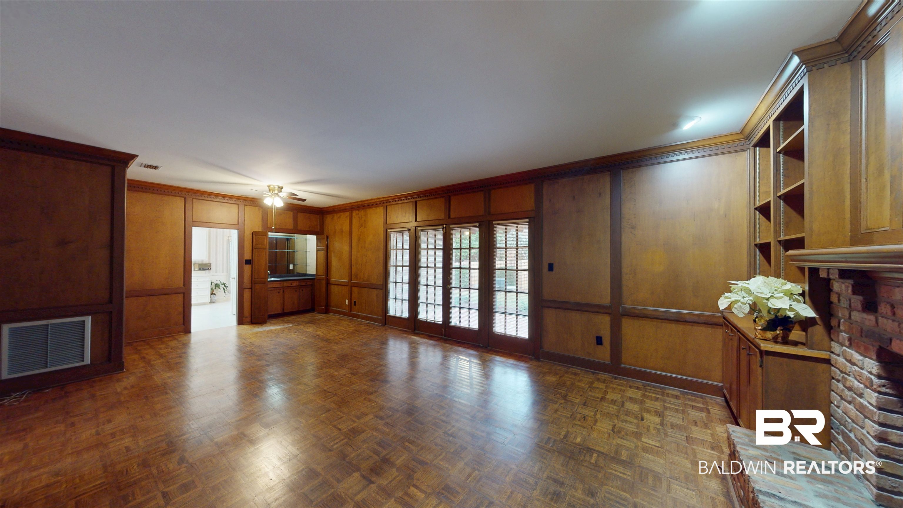 53 Warwick Road Mobile, AL 36608 - Photo 24 of 45 Den with crown molding, wooden walls, a decorative wall, and ceiling fan