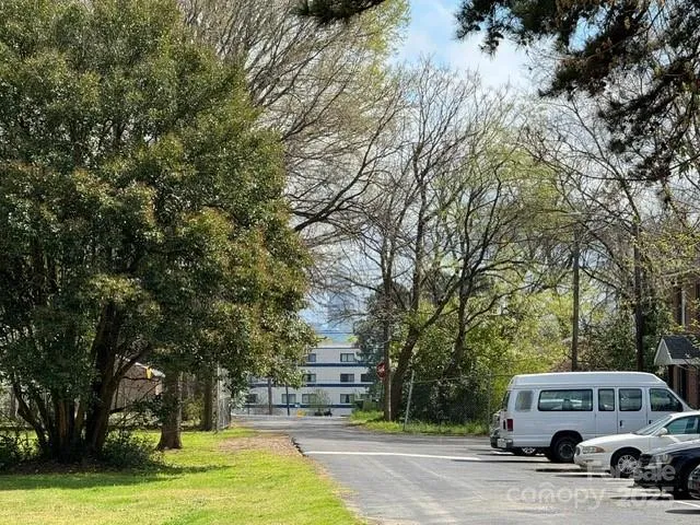 a view of a cars park on the side of road