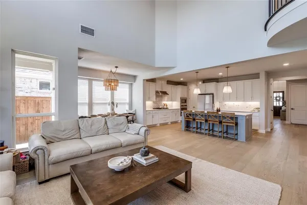 a living room with furniture a table and a large window
