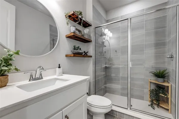a bathroom with a sink toilet and shower