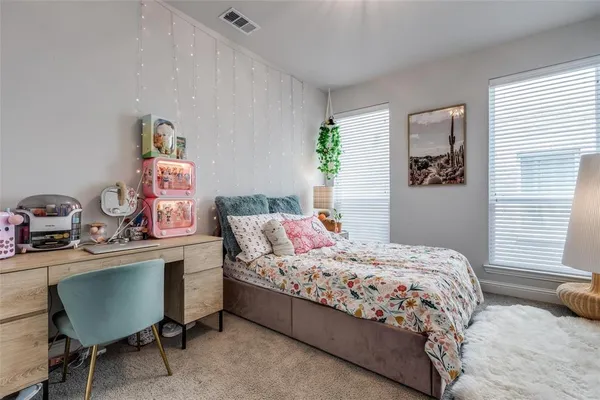 a bedroom with a bed and a desk