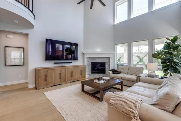 a living room with furniture a flat screen tv and a fireplace